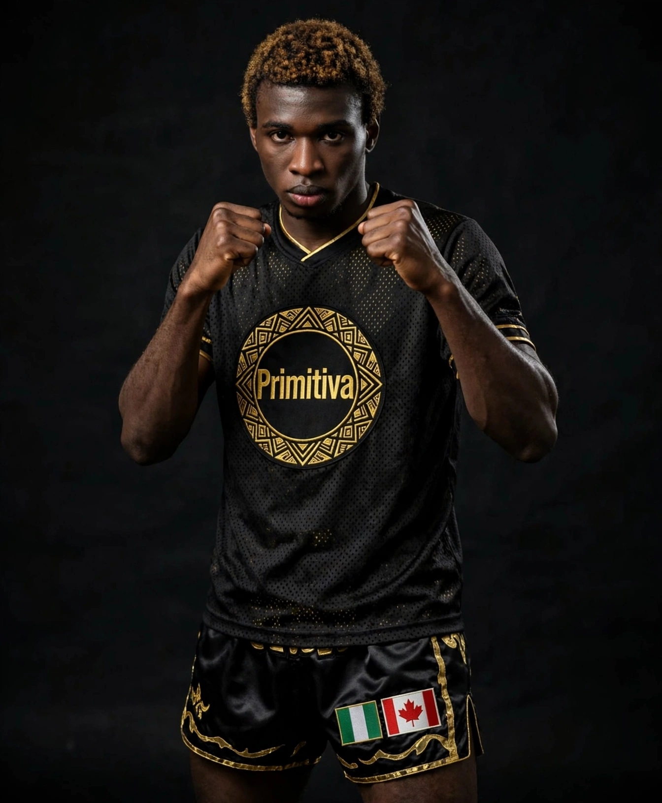 Robson Etuke Diamond wearing the black and gold Primitiva fight set in a fight stance